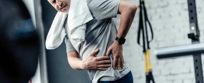 Man exercising has back pain