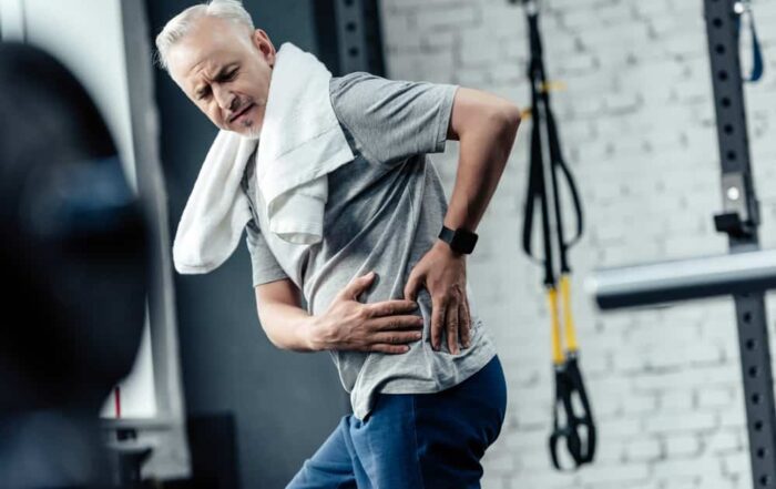 Man exercising has back pain