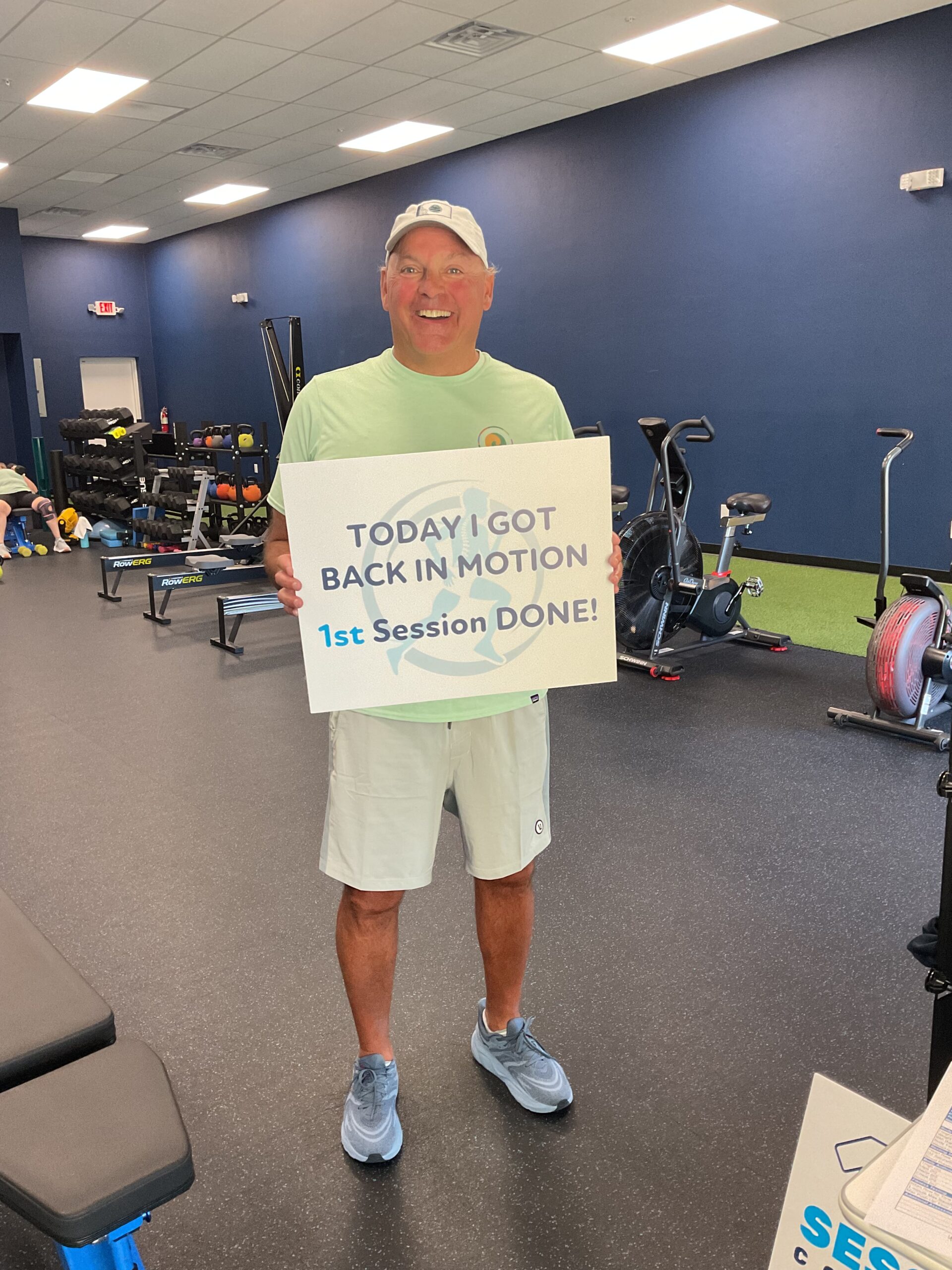 Client holding a First Session Done sign